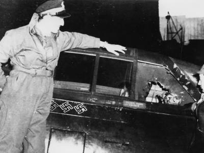 Pilot of the 78th Fighter Group inspects the damaged cockpit of a P-47 Thunderbolt