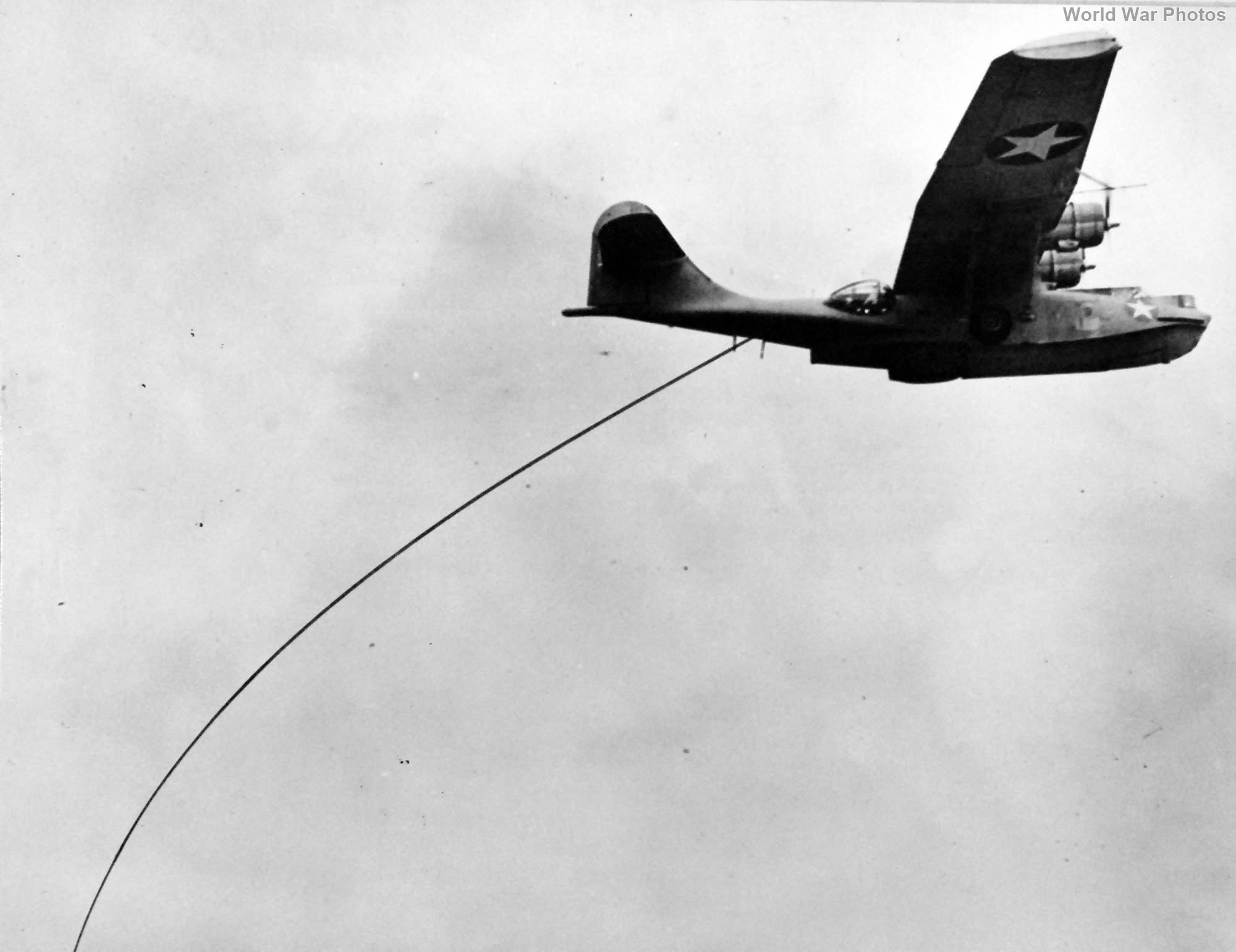 PBY in flight towing the magnetic airborne detector