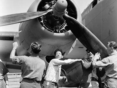 Workmen perform final checks on a PV-1