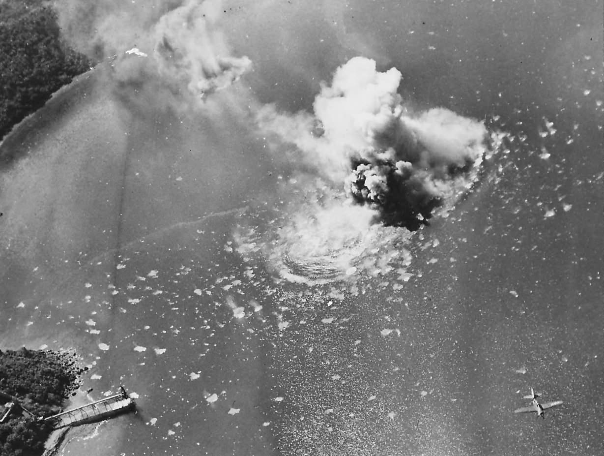 SB2C of VB-18 from USS Intrepid blasts Japanese ship at Balanacan Harbor