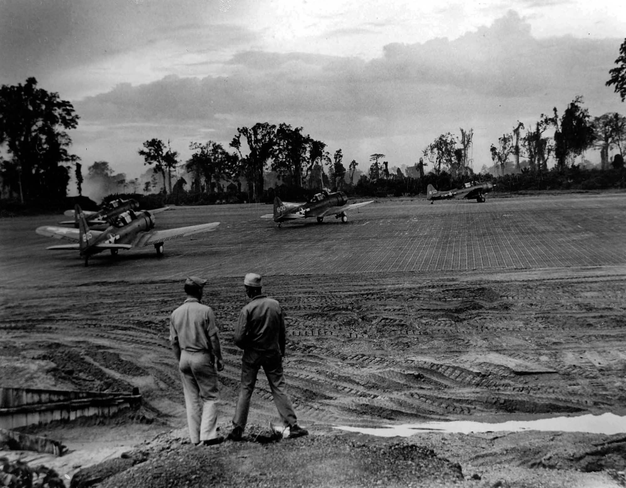 Marine SBD white 805, 800, 850 taxi on the runway at Bougainville 1944