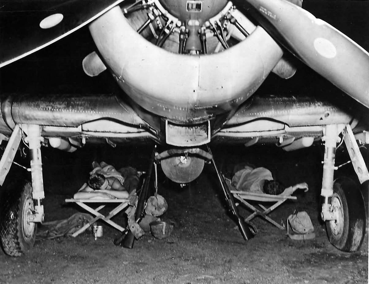Marines sleeping under wings of SBD Dauntless on Bougainville
