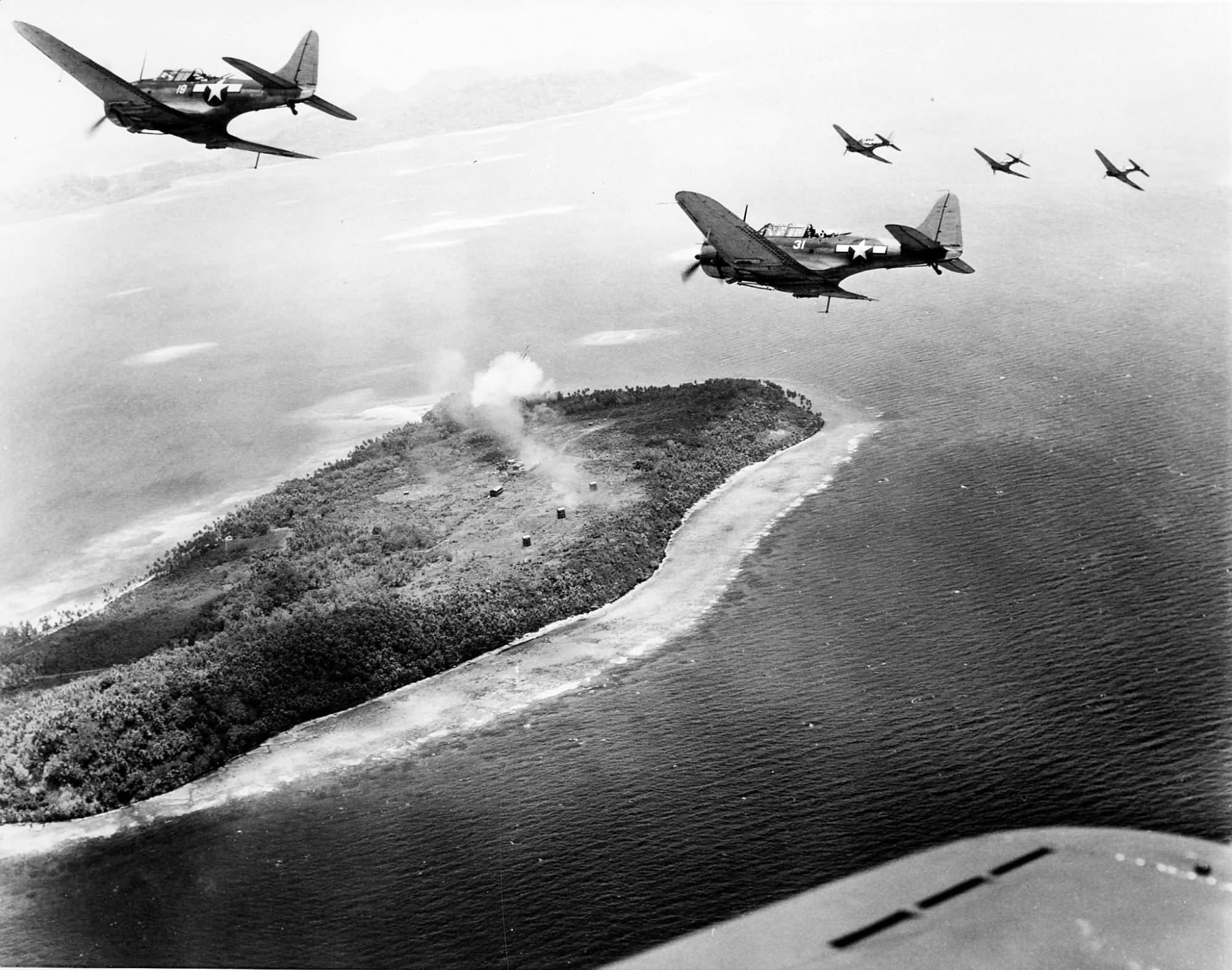 SBD-5 from VB-16 off the carrier Lexington (CV-16) fly low over Japanese installations on Param Island Truk Atoll on April 29, 1944