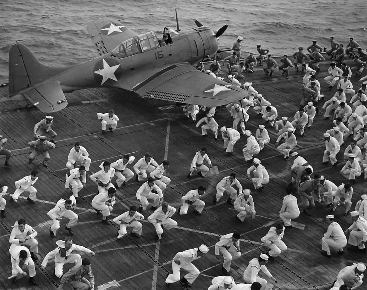 SBD black 15 and sailors duck walk for exercise aboard carrier