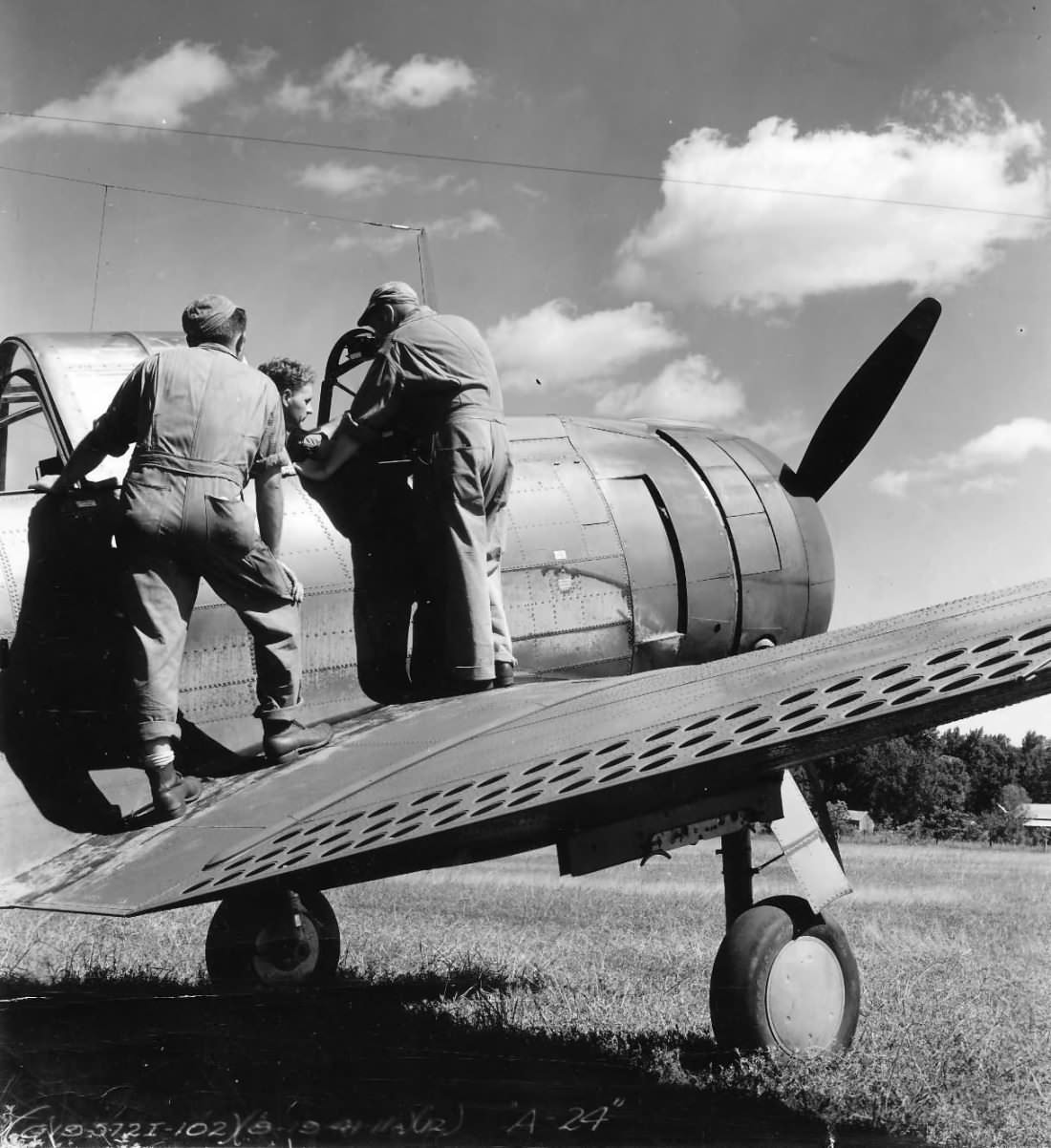 USAAC ground crew talking to pilot on a A-24, October 1941