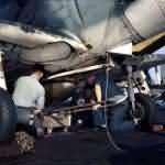 Aviation ordnancemen load bomb