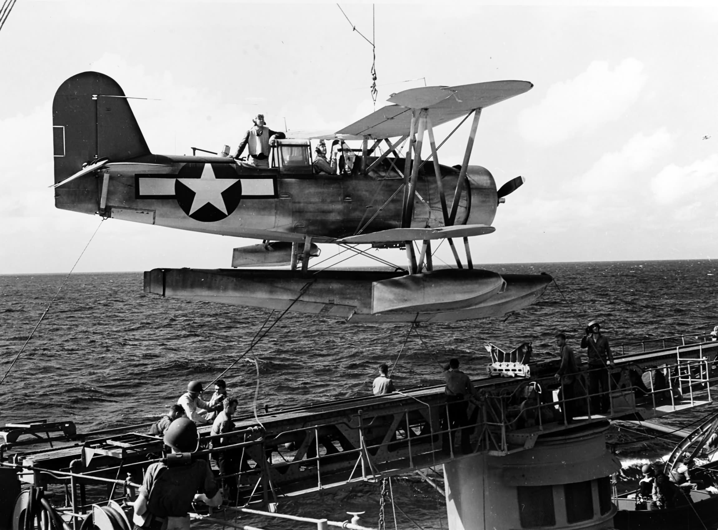 Floatplane Curtiss SOC is lowered onto the port catapult of USS Minneapolis (CA-36) during Wake Raid – 5 October 1943