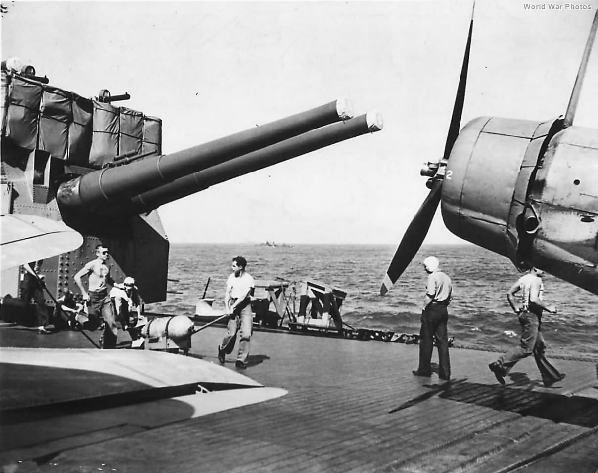 Carrier reloading crew rushing bombs to returning planes 1942