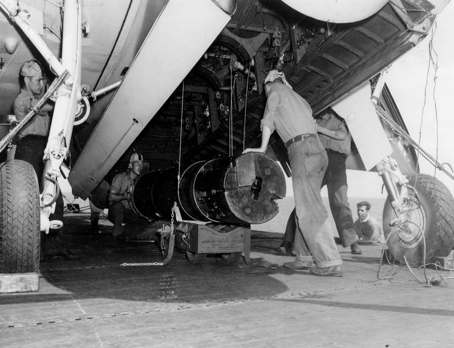Ordnancemen load Mk 10 mines into the bomb bay of a TBF Avenger VT-16 on the flight deck of the carrier USS Lexington (CV-16) on March 29, 1944