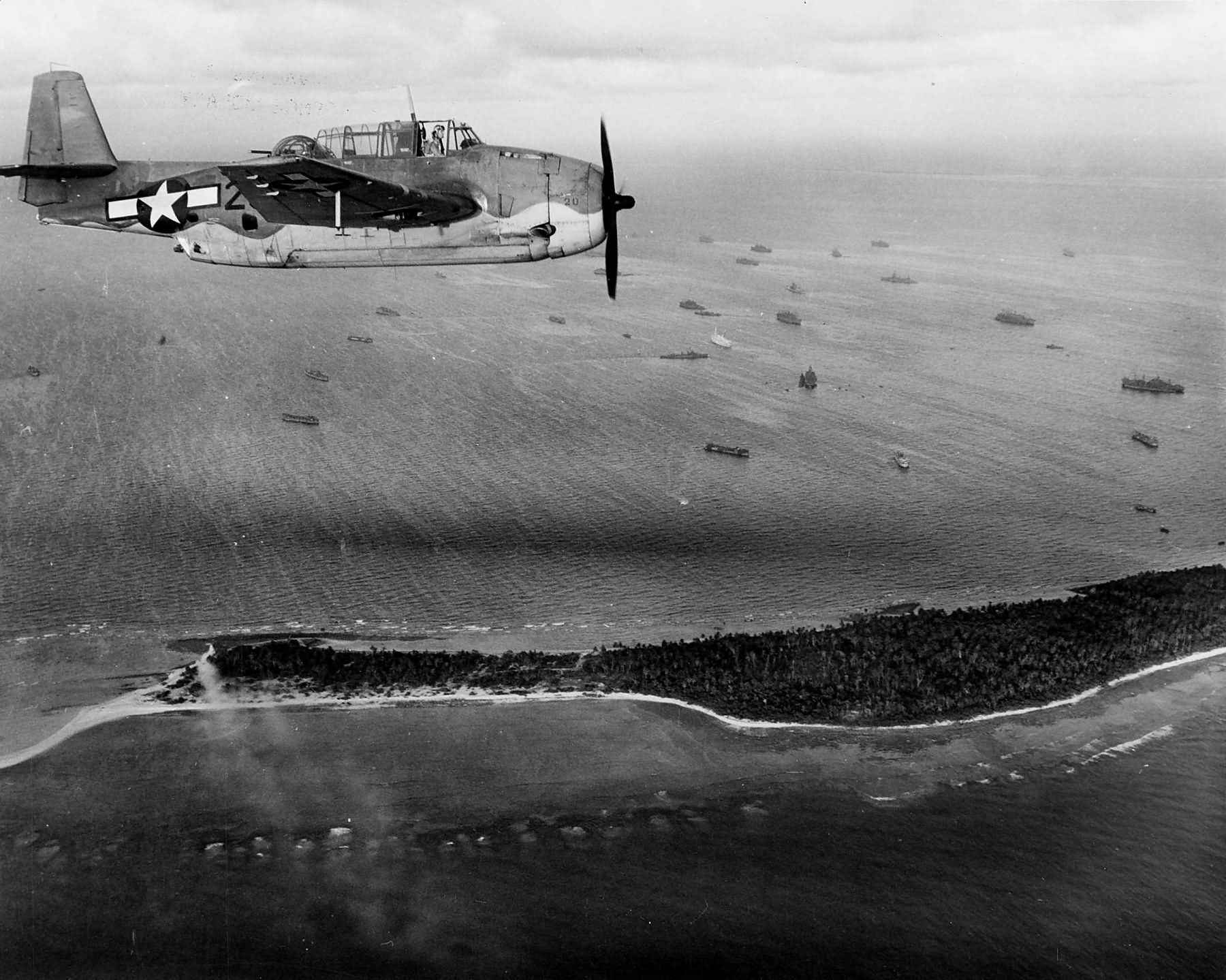 TBF flies over an anchorage full of ships in the Marshall Islands on May 23 1944