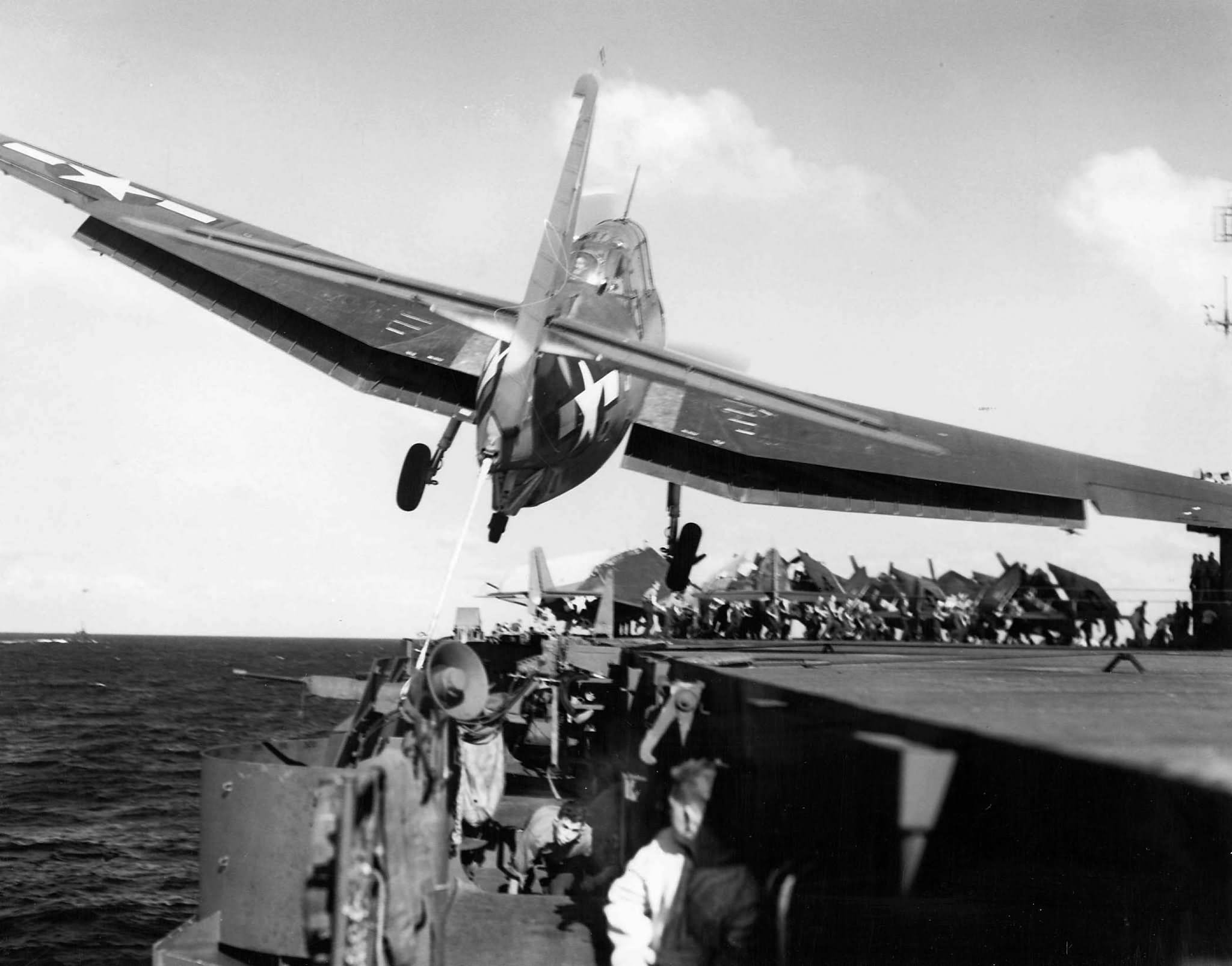 Grumman TBF of VT-31 drifts over the port catwalk of the carrier USS Cabot (CVL-28) – December 1943