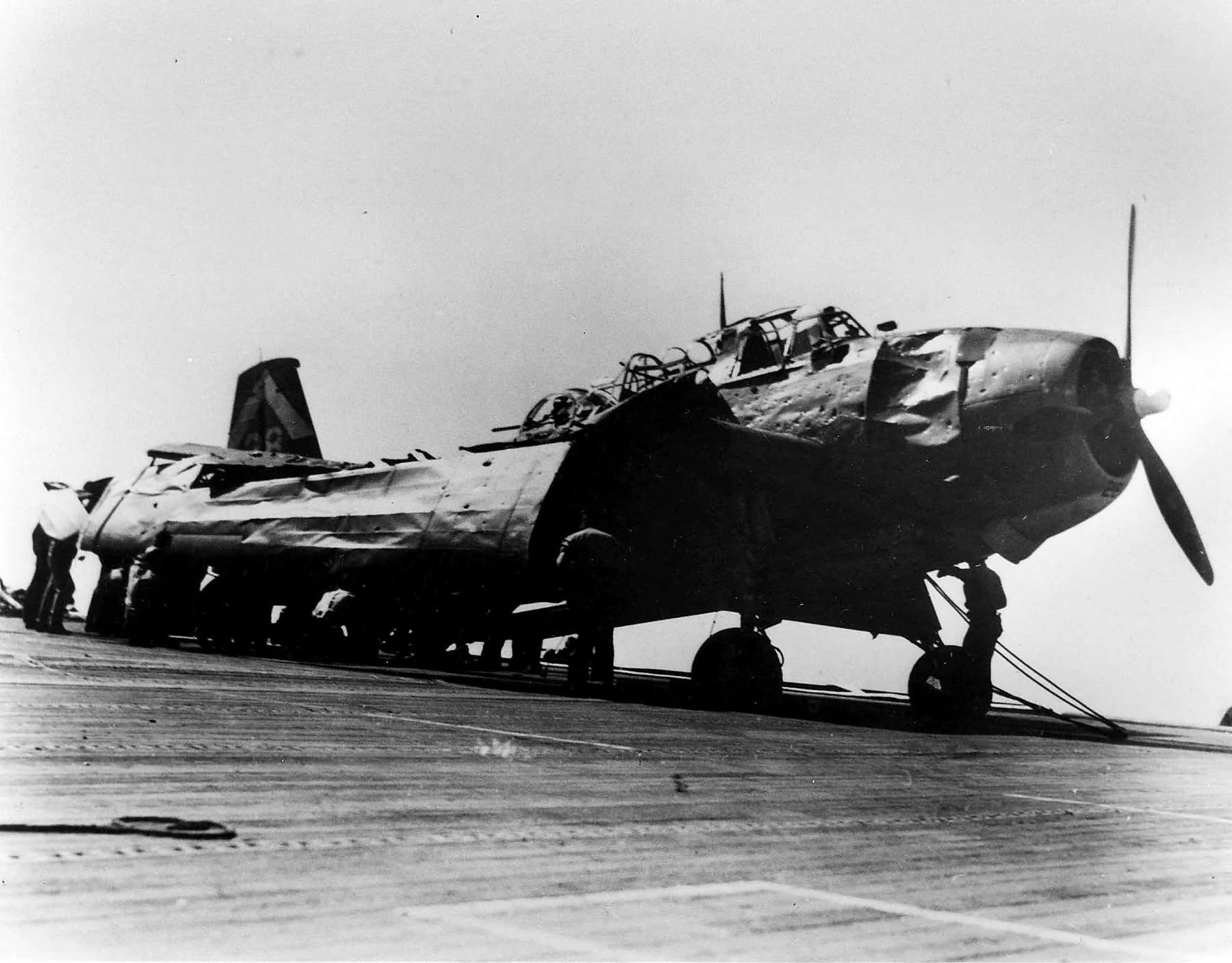 TBM-1C Avenger of VC-80 on the flight deck of the USS Manila Bay (CVE-61) damaged by a kamikaze hit – January 5. 1945