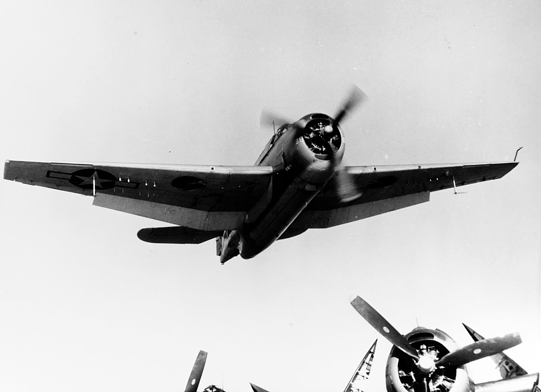 TBM-1 Avenger flies low over the flight deck of USS Makin Island