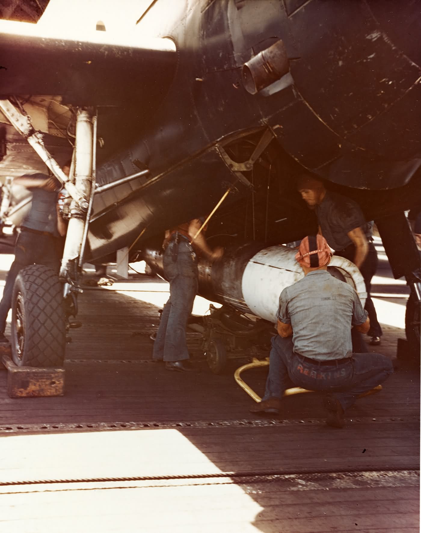 Crewmen load a Mark XIII torpedo on a TBM Avenger USS Bennington CV-20