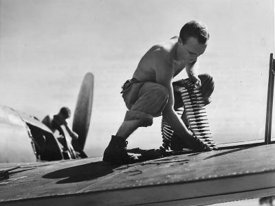 Marine ground crewman loads ammo