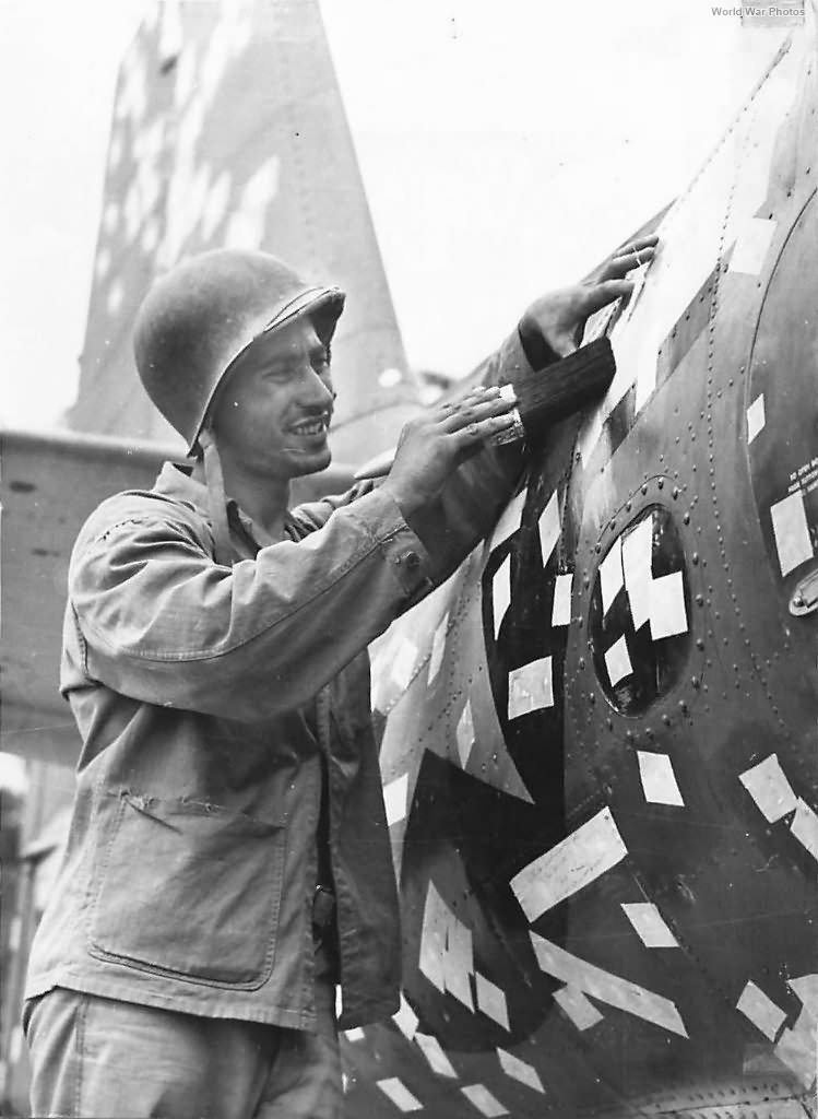 Marine patches 400 shrapnel holes in TBF on Bougainville 1944