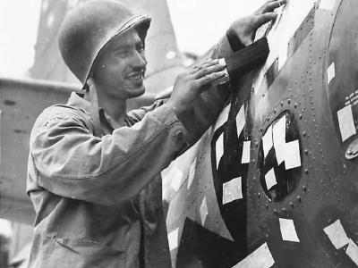Marine patches 400 shrapnel holes in TBF on Bougainville 1944