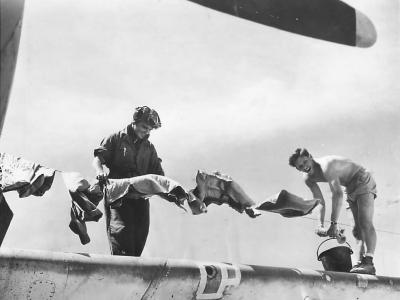 Marine pilots hang laundry above wing of Avenger