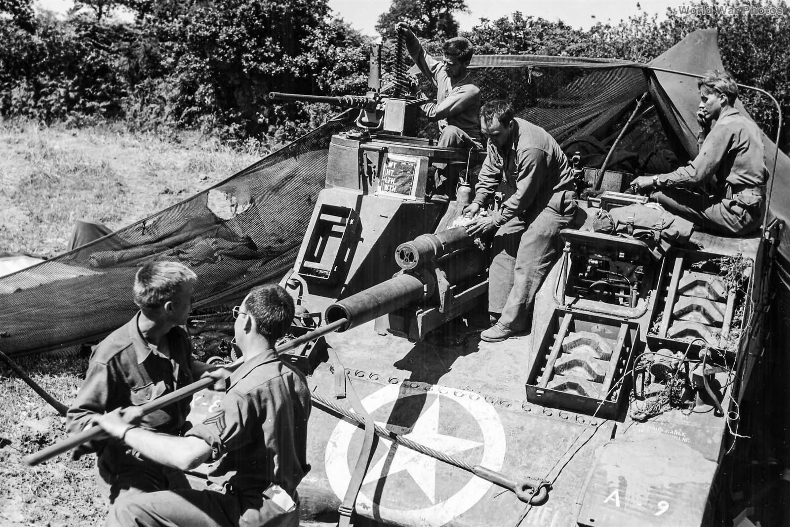 Crew of a 6th Armored Division swabs the tube of M7 late Summer 1944