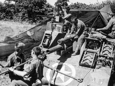 Crew of a 6th Armored Division swabs the tube of M7 late Summer 1944