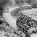 29th Marines hitch ride on M7 moving along a coastal road near Ghuta Village Okinawa