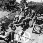 Crew of a 6th Armored Division swabs the tube of M7 late Summer 1944