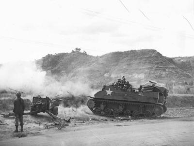 Artillery guns blast Japanese position on Luzon