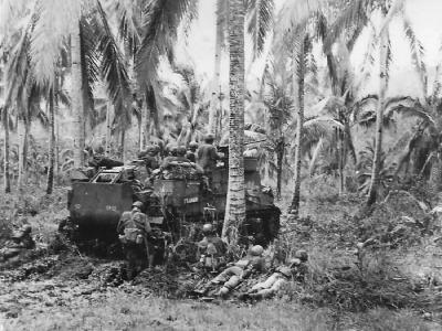 M7 Priest and US infantrymen advancing on Catman Hill on Leyte