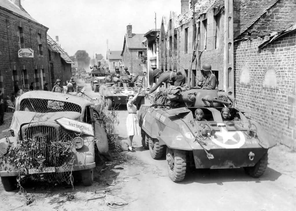 M8 Greyhound Armored Cars of the 2nd Cavalry Group (Mechanized) Enter Brehal Normandy August 2 1944