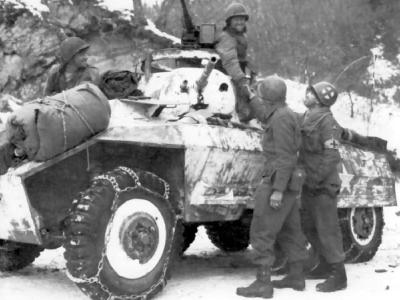 Troops of 84th Division shake hands with an M8 armored car crew