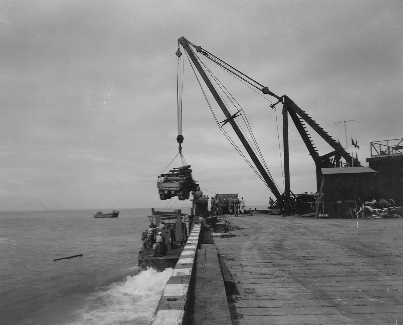 Crane Loads Truck Into Landing Craft On Biak 1944