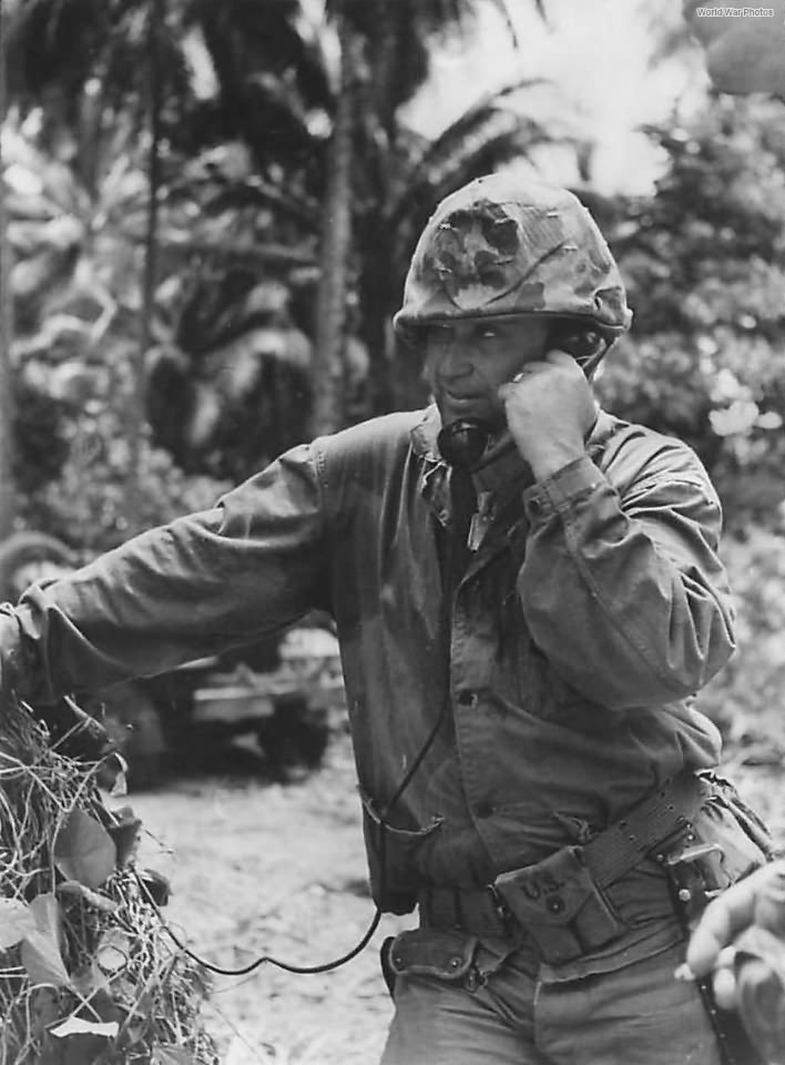 Marine directs artillery from field telephone