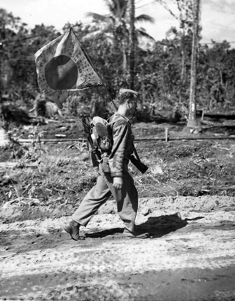 Marine with captured japanese battle flag on Bougainville