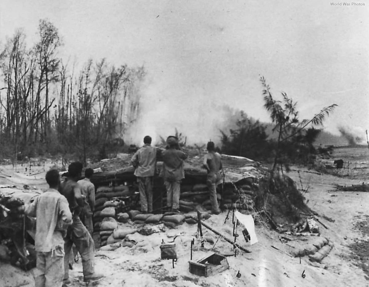 Protected by pillboxes Americal Division troops watch dive bombers