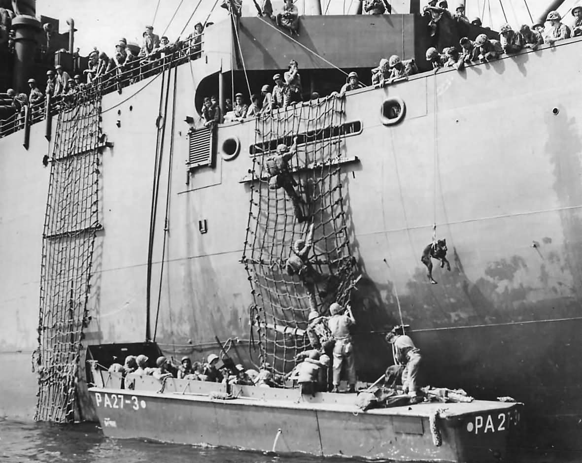 Troops and dog board assault boat for Bougainville Invasion 1943