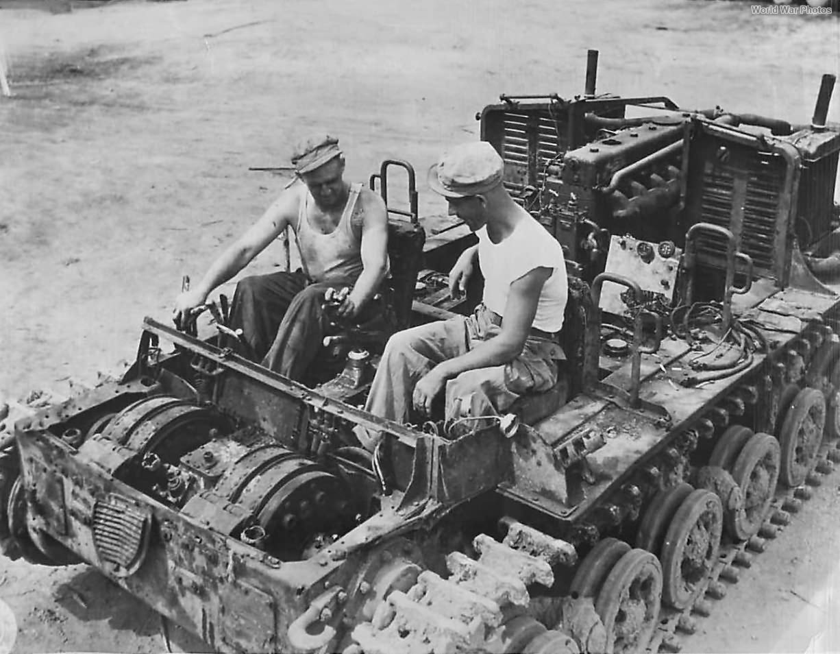 Troops of the 23rd Americal Division riding an abandoned Japanese tractor on Bougainville