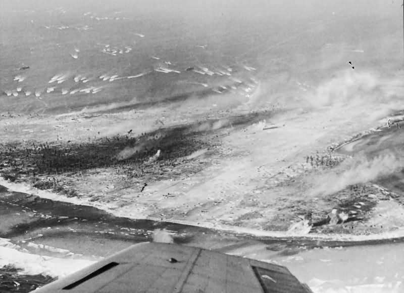 Landing craft approaching Eniwetok In the foreground is a Japanese airfield