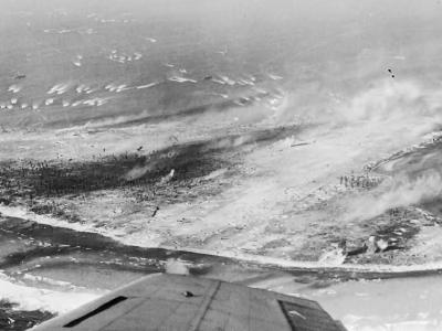 Landing craft approaching Eniwetok In the foreground is a Japanese airfield