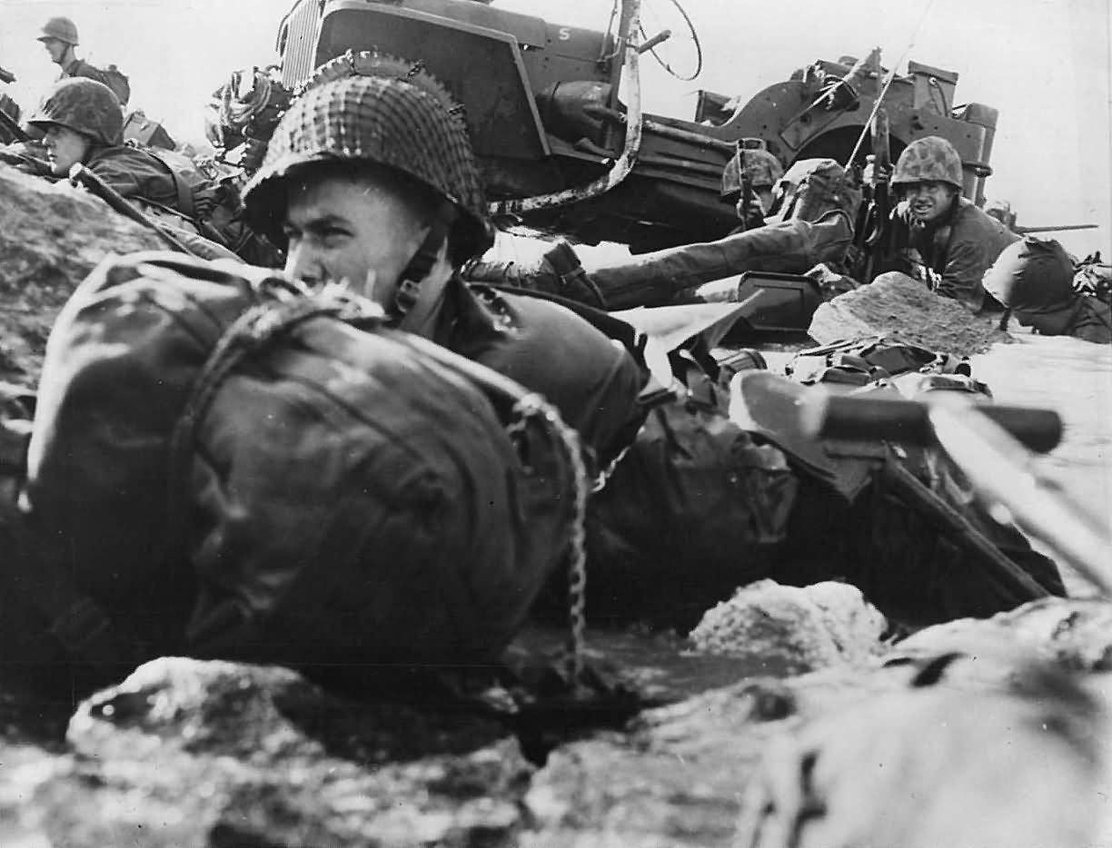 Marines Crouch on Beach during Invasion of Eniwetok