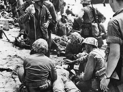 Marines Give Plasma to Wounded Soldier on Eniwetok Pacific