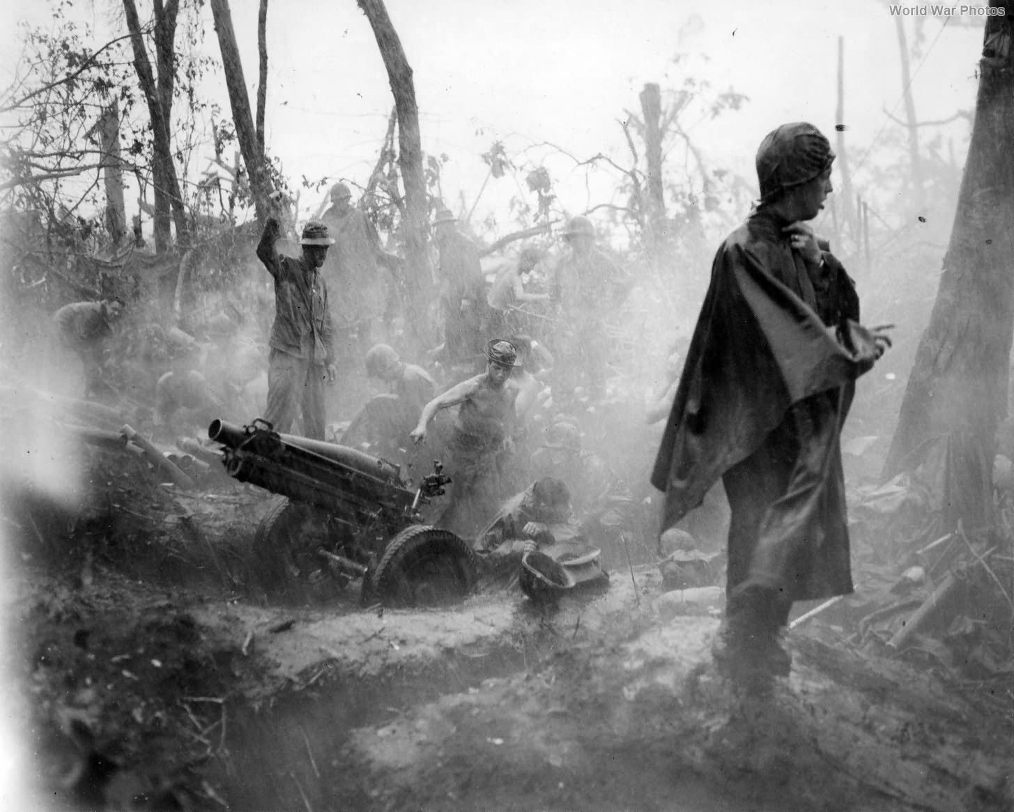 Marines manning 75mm howitzer in rain on Cape Gloucester