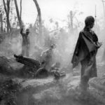 Marines manning 75mm howitzer in rain on Cape Gloucester