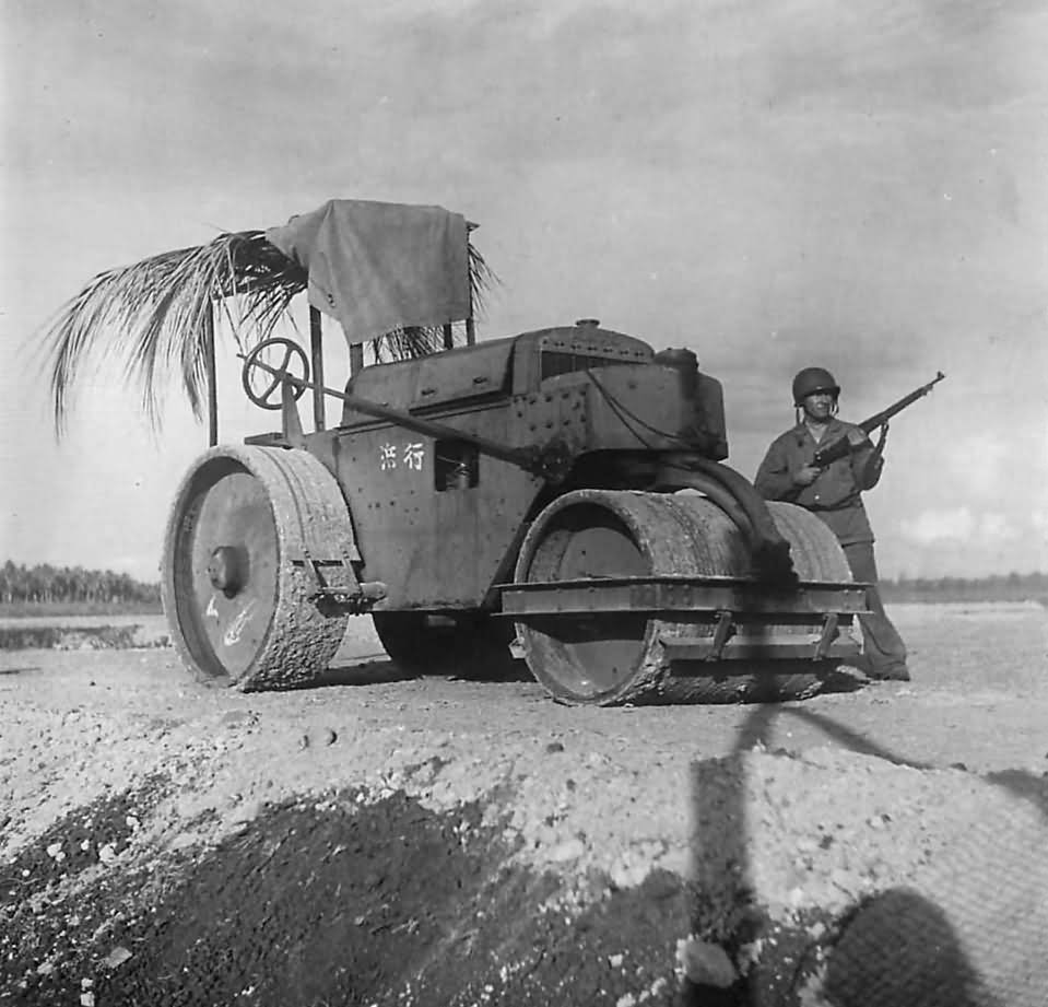 Marine guards a captured Japanese steamroller at airfield on Guadalcanal 1942