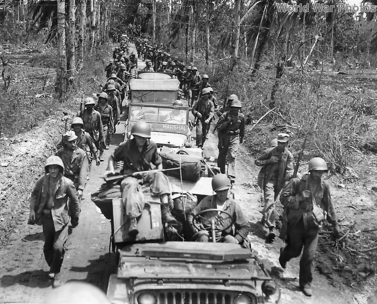 Marines and Jeeps moving along the Aganga Piti Road on Guam