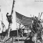 American Flag flies over Guam beachhead as troops move inland