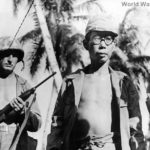 Captured Japanese soldier under Marine guard on Guam