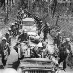 Marines and Jeeps moving along the Aganga Piti Road on Guam