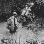 Marines crossing stream