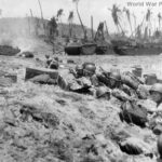 Marines shelter on beach during Invasion of Guam