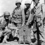 Marines with recovered plaque from Marine Barracks on Orte